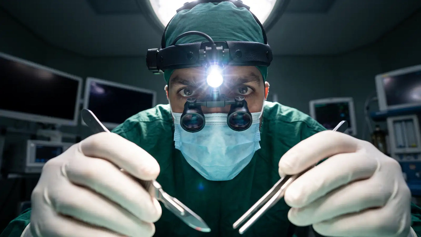 Surgeon wearing a head-mounted camera while performing an operative procedure.